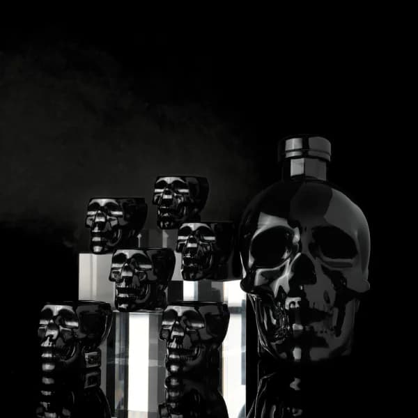 Crystal Head Onyx vodka in matte black skull bottle with skull shot glasses — agave vodka filtered through Herkimer diamonds