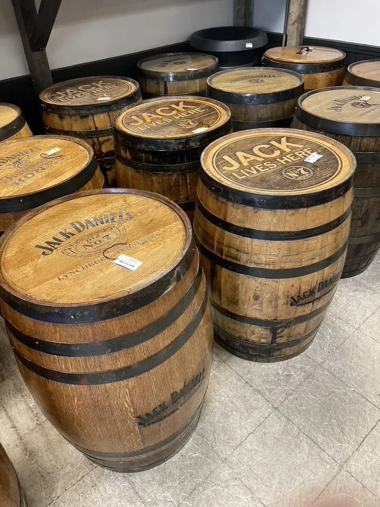Whole Jack Daniel's barrels with Jack Lives Here barrel heads and price tags for sale in a Lynchburg barrel shop