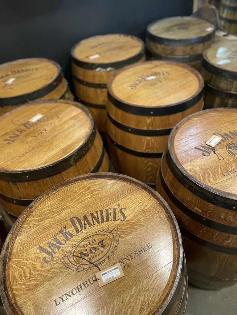 Rows of Jack Daniel's barrels with Old No. 7 Lynchburg Tennessee heads and price tags