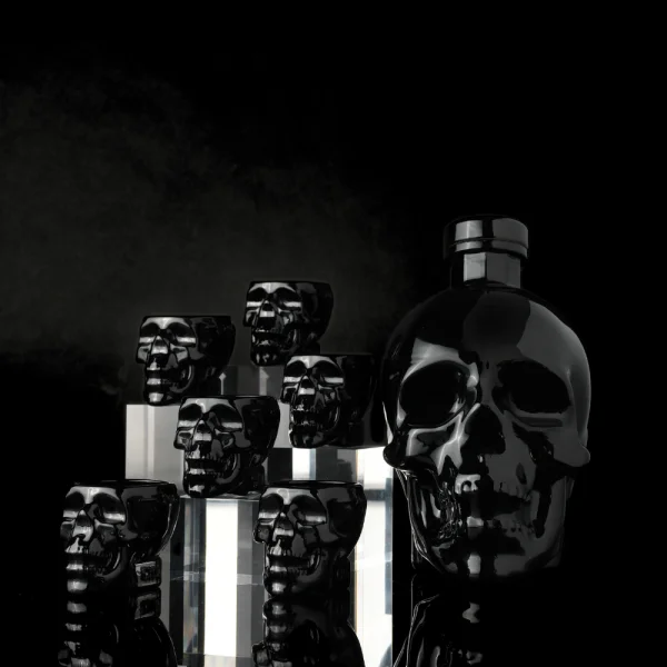 Crystal Head Onyx vodka in matte black skull bottle with skull shot glasses — agave vodka filtered through Herkimer diamonds